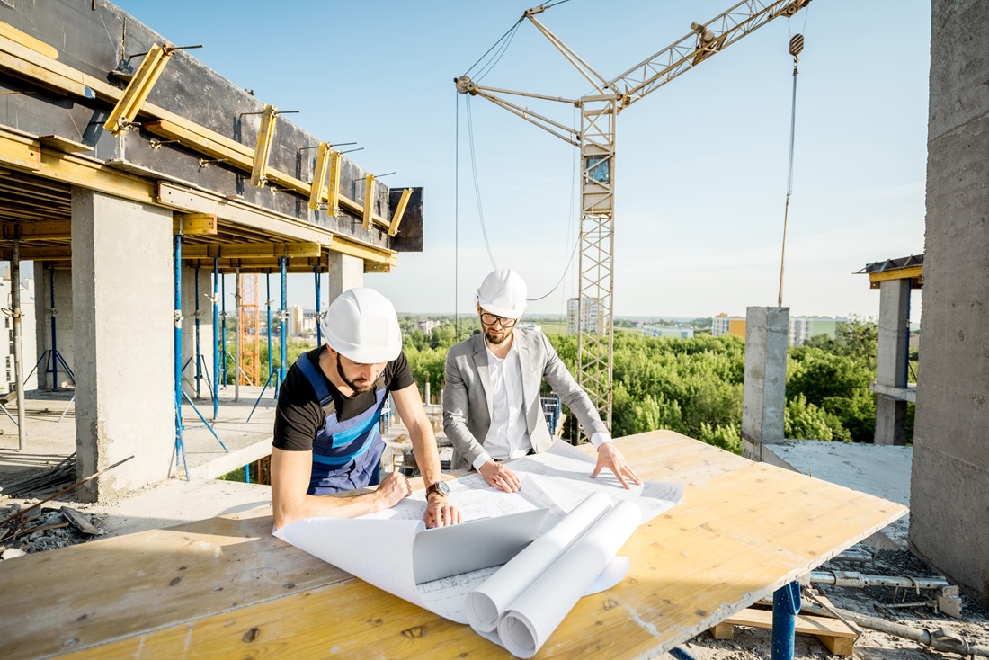 Engineer with worker at the construction site